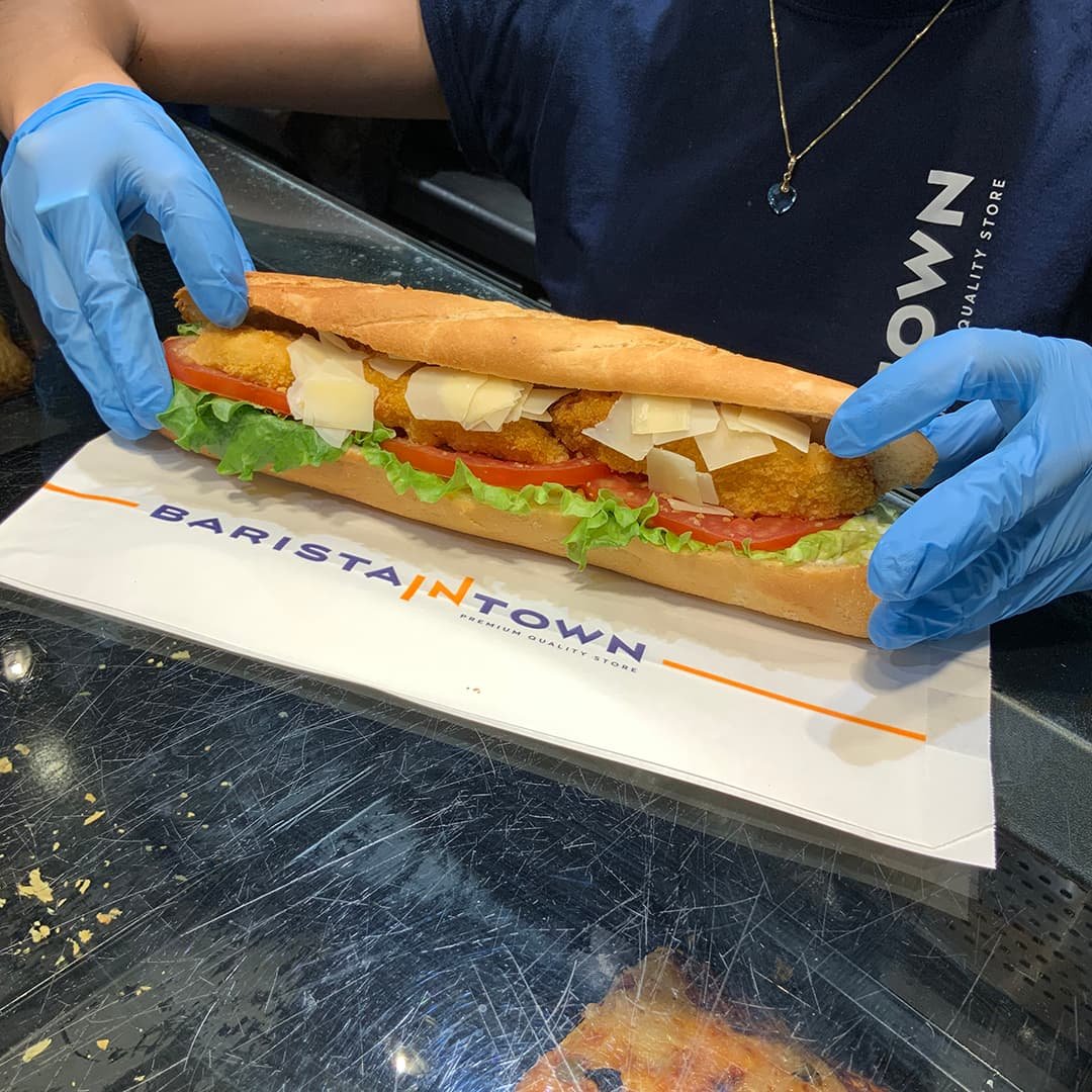 Barista in Town baguette on branded paper