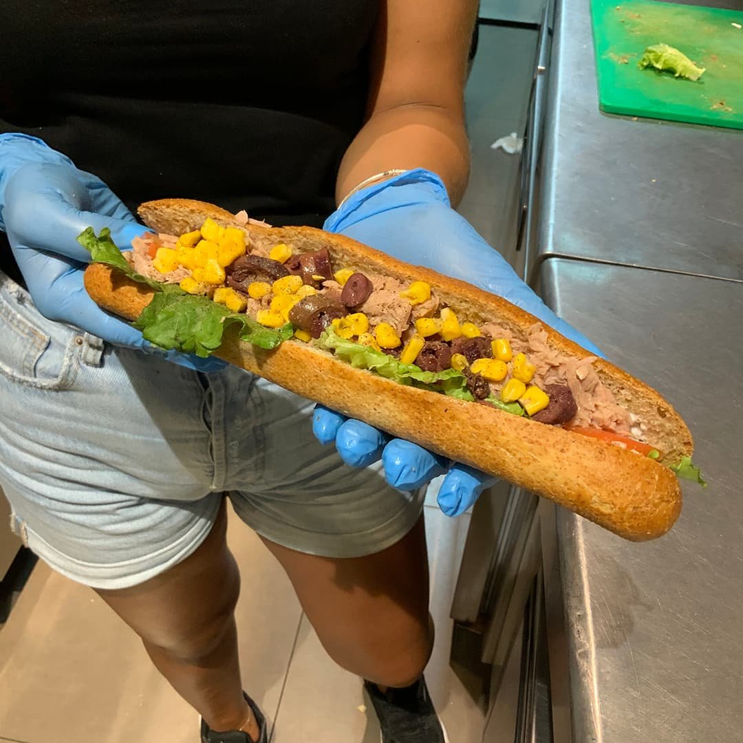 Baguette with breaded chicken, tomato and parmesan